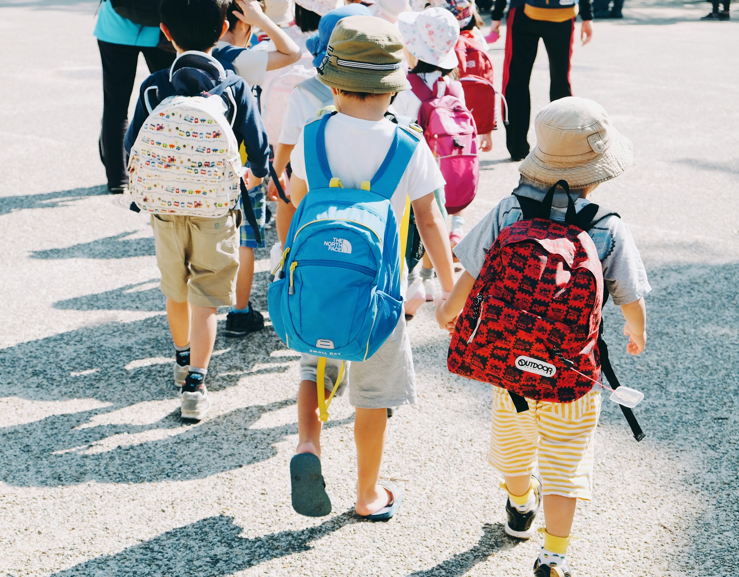 Children walking along a road to school